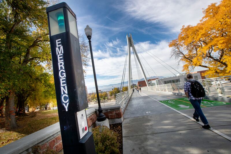 FILE - Students pass a call box near the Legacy bridge at the University of Utah in Salt Lake City.