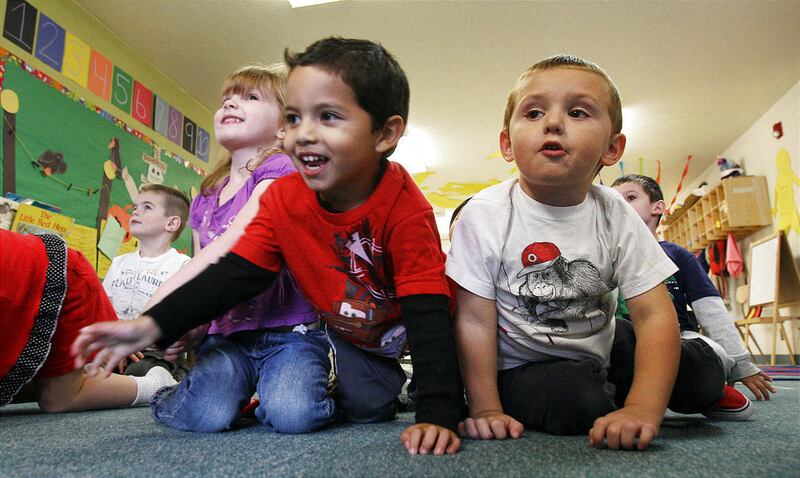 Christopher Ortizgns, front left, and Maddox Weight crawl like spiders at the Wee Care Center at Utah Valley University in Orem, in this Monday, Sept. 24, 2012 file photo. The Wee Care Center began in 2001 and provides low-cost child care for parents atte