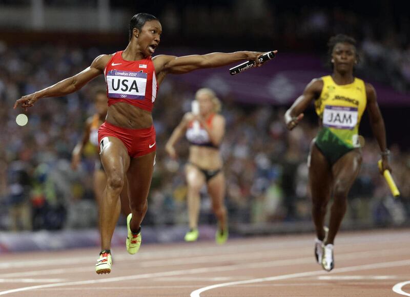 United States' Carmelita Jeter reacts as she crosses the finish line to win the women's 4 x 100-meter relay during the athletics in the Olympic Stadium at the 2012 Summer Olympics, London, Friday, Aug. 10, 2012. The United States relay team set a new worl