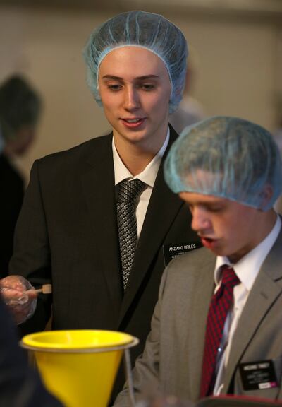 Elder Austin Briles, from South Carolina, works with fellow missionaries at the Missionary Training Center in Provo to fill bags of "Apple Pie Oats" as they participate in an annual service project with Feeding Children Everywhere to address the issue of
