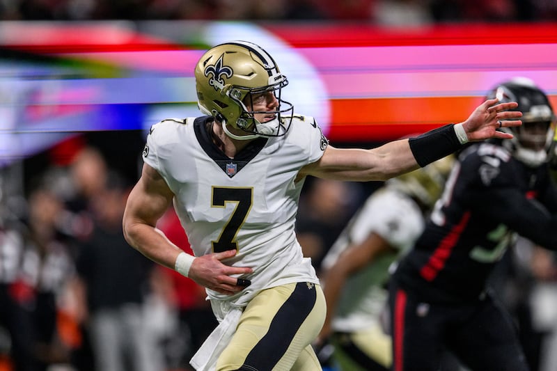 New Orleans Saints quarterback Taysom Hill (7) works during the first half of an NFL football game against the Atlanta Falcons.