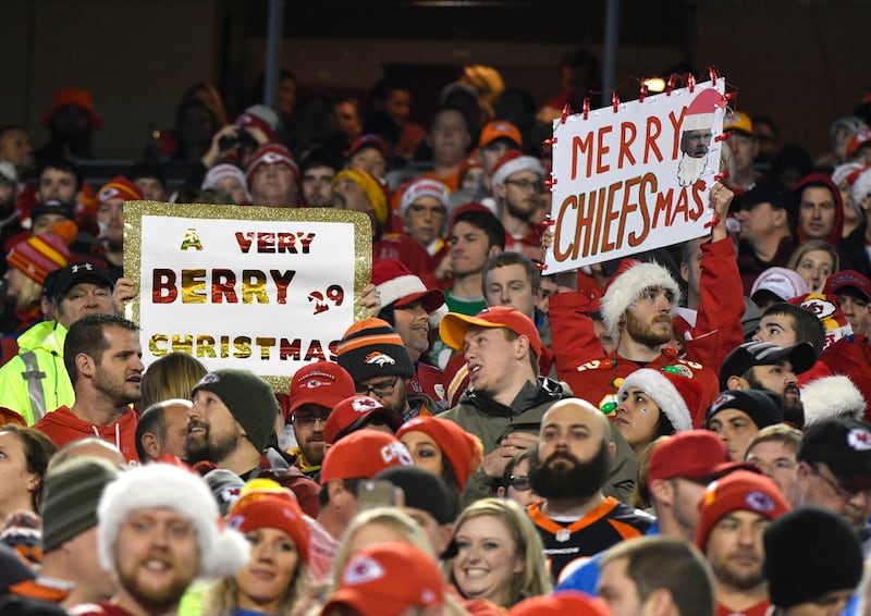 Kansas City Chiefs fans hold up Christmas greeting signs during a game, Sunday, Dec. 25, 2016.