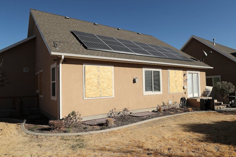 The windows of a house on Snow Moon Place in South Jordan are boarded up on Sunday, Nov. 1, 2020.
