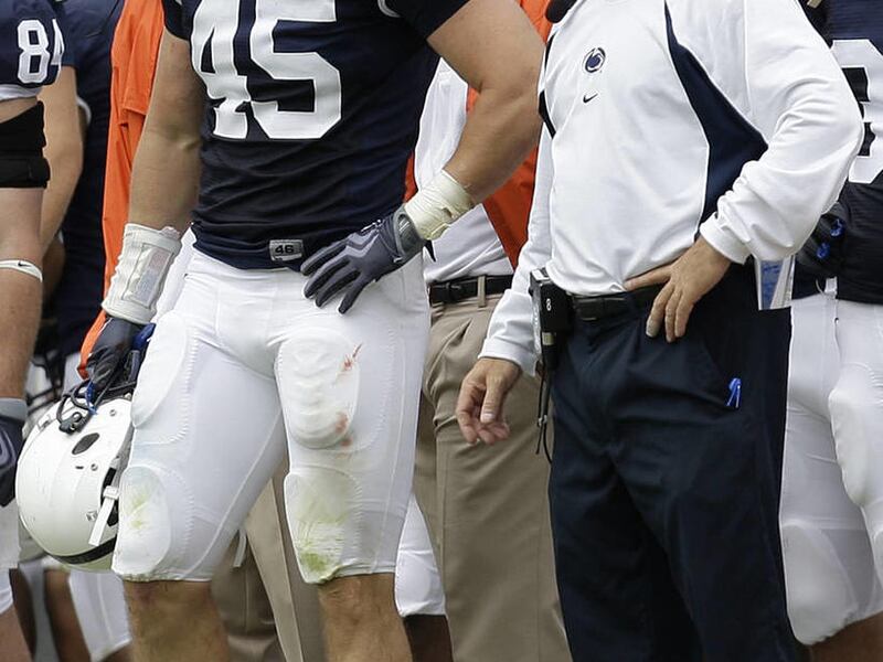 In this Saturday, Sept. 12, 2009, photo, Penn State linebacker Sean Lee (45) stands with assistant coach Tom Bradley on the sideline. Bradley will take the position as interim head coach for the remainder of the season.