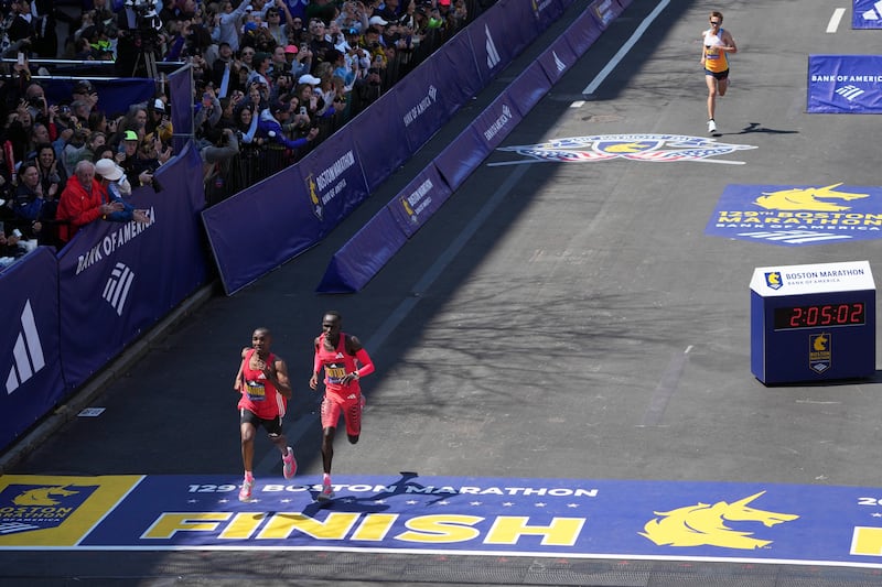 Conner Mantz, of the United States, top right, chases Alphonce Felix Simbu, left, and Cybrian Kotut towards the finish line during the Boston Marathon, Monday, April 21, 2025, in Boston.