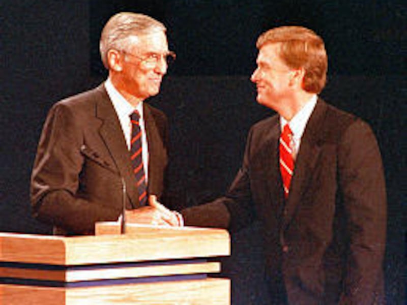 Sen. Lloyd Bentsen, left, shakes hands with Sen. Dan Quayle after their vice presidential debate in 1988. Bentsen died Tuesday.