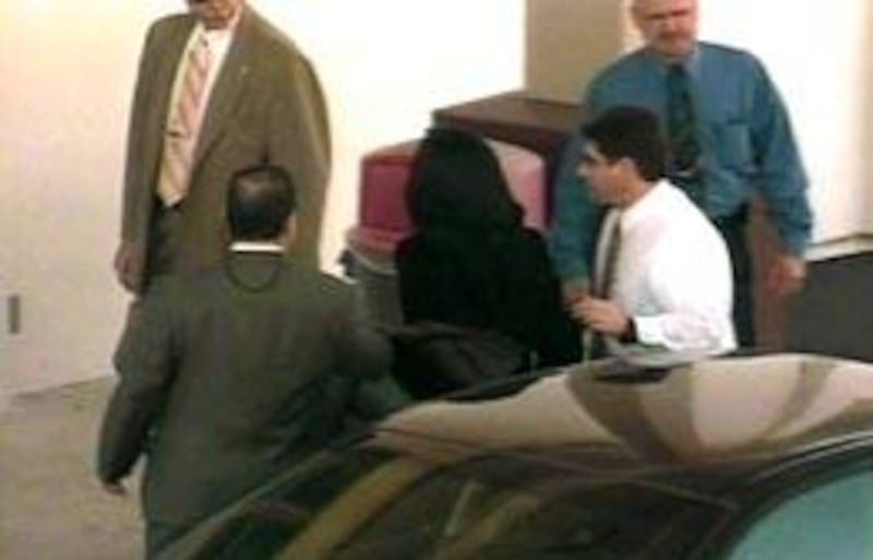 A handcuffed Michael Jackson walks into the Santa Barbara jail Thursday to face child molestation charges.