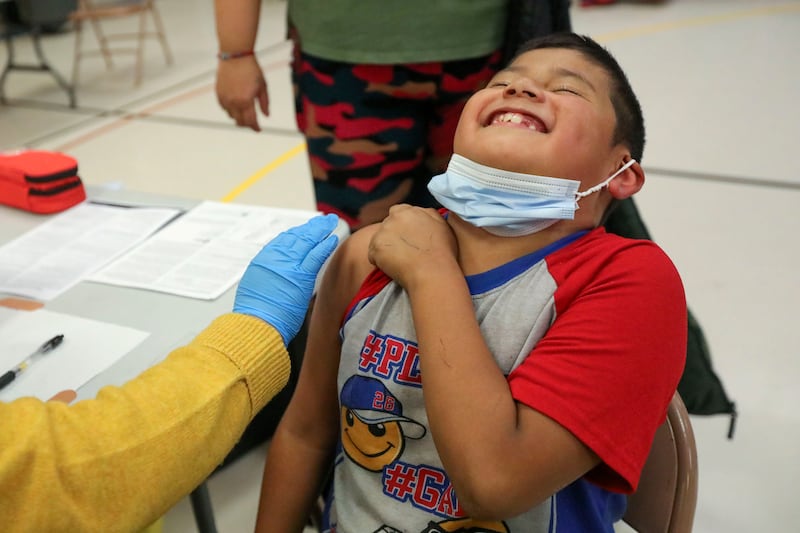 Angel Aguilar, 8, laughs before getting a COVID-19 vaccination at Hillsdale Elementary School in West Valley City on Monday, Nov. 8, 2021.