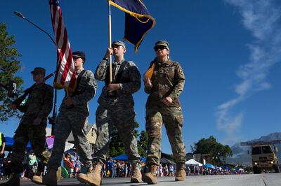 Army soldiers march the U.S. and Utah flags down the street during the Freedom Festival’s July 4th Grand Parade in Provo on Wednesday, July 4, 2018.