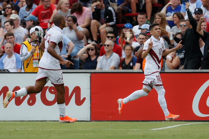Venezuela midfielder Jefferson Savarino (10) celebrates after scoring with forward Jose Salomon Rondon, left, during the first half of an international friendly soccer match against the United States, Sunday, June 9, 2019, in Cincinnati. (AP Photo/John Mi