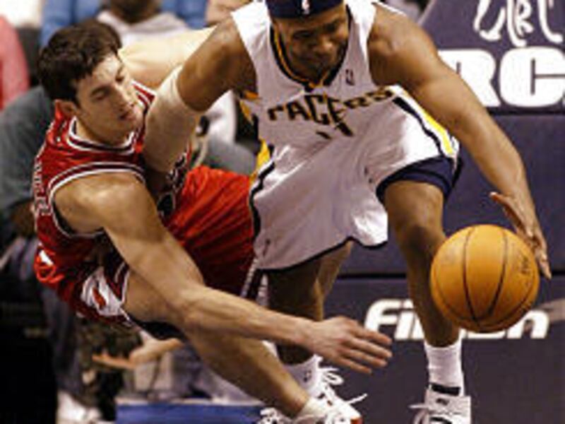 Indiana Pacers' Jamaal Tinsley, right, pushes Chicago's Kirk Hinrich as they go after a loose ball