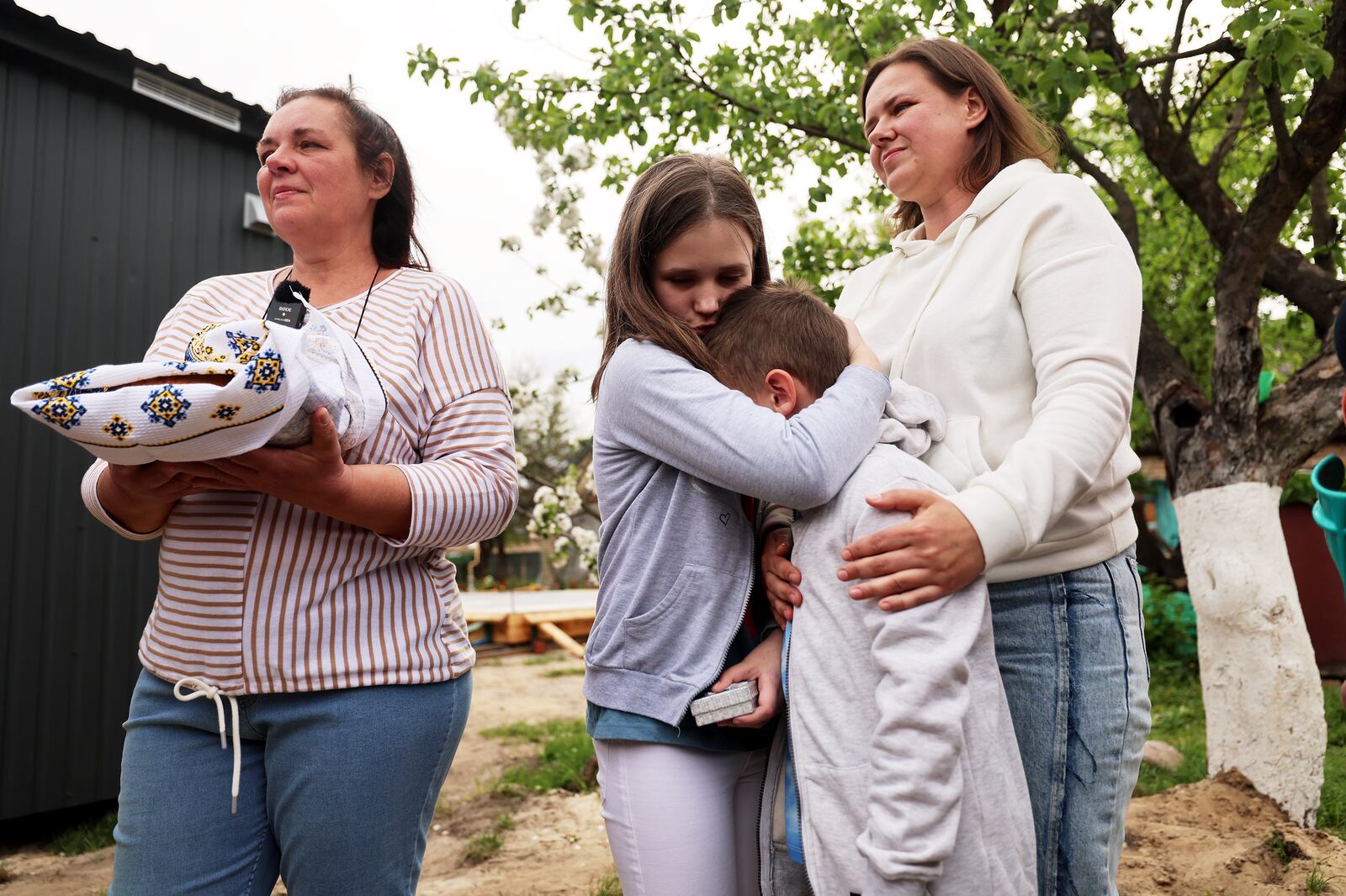Polinka tries to console her brother Yaroslav as they are given the keys to their new home in Ukraine.