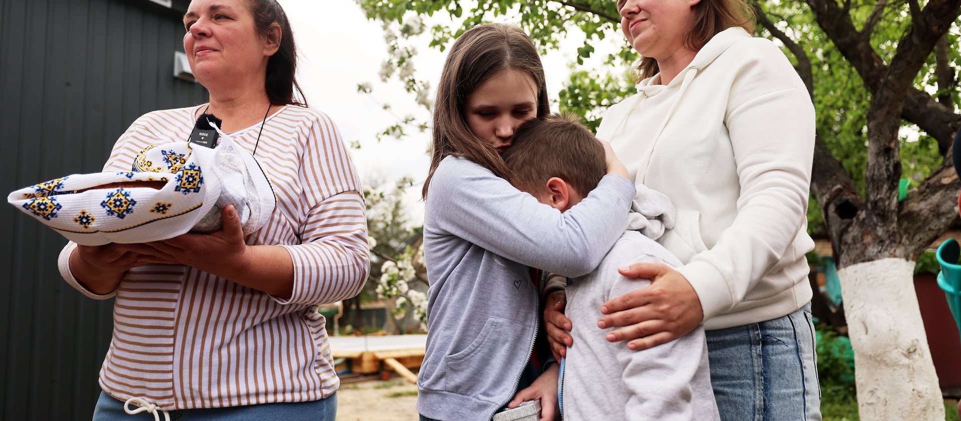 Polinka tries to console her brother Yaroslav as they are given the keys to their new home in Ukraine.