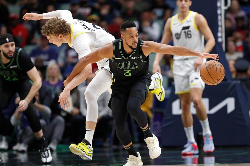 New Orleans Pelicans guard CJ McCollum (3) steals the ball from Utah Jazz forward Lauri Markkanen (23) during the first half of an NBA basketball game in New Orleans, Tuesday, Jan. 23, 2024.