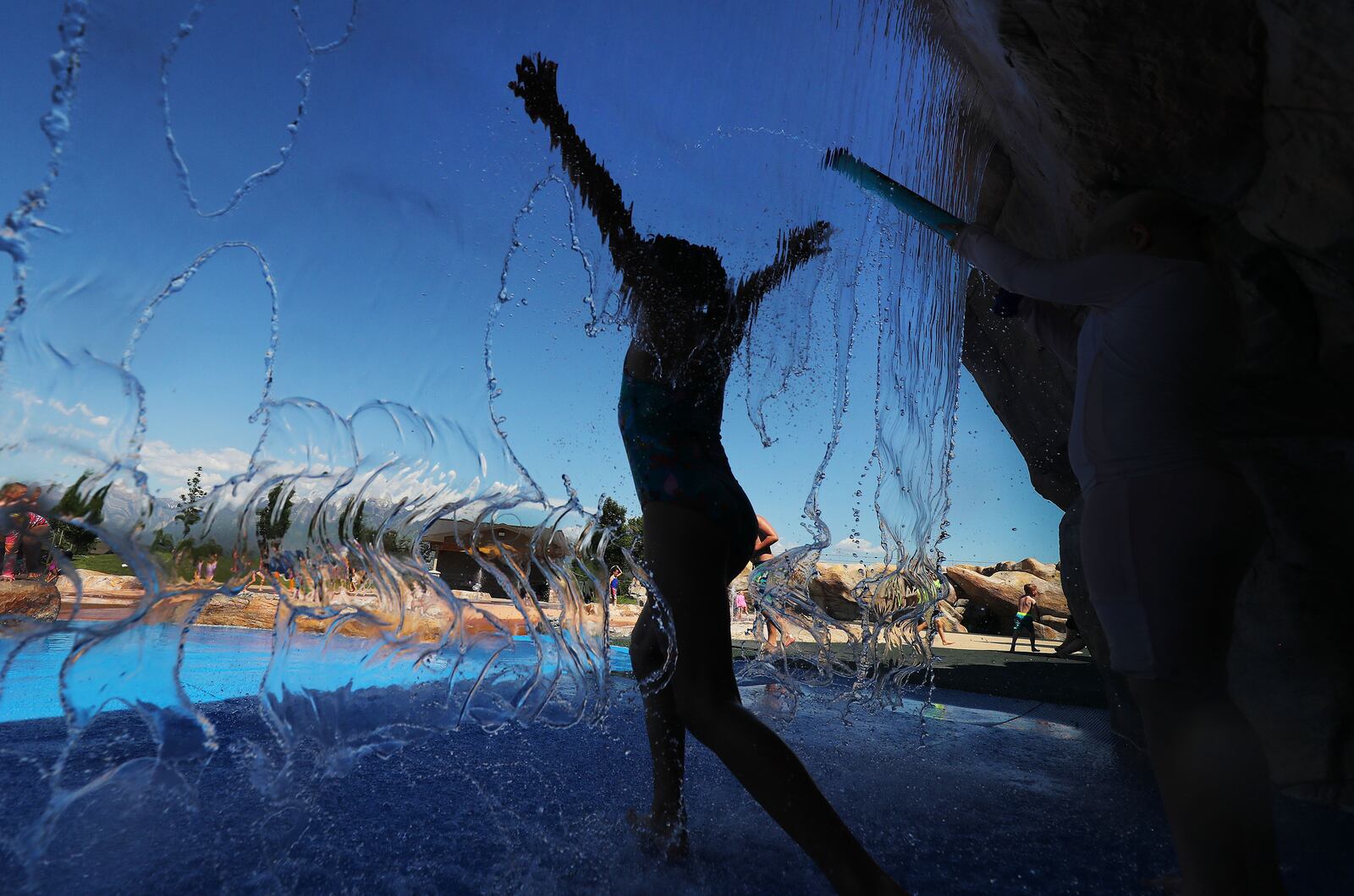 Children cool off in the water at Wardle Fields Regional Park splash pad in Bluffdale on June 3, 2021.