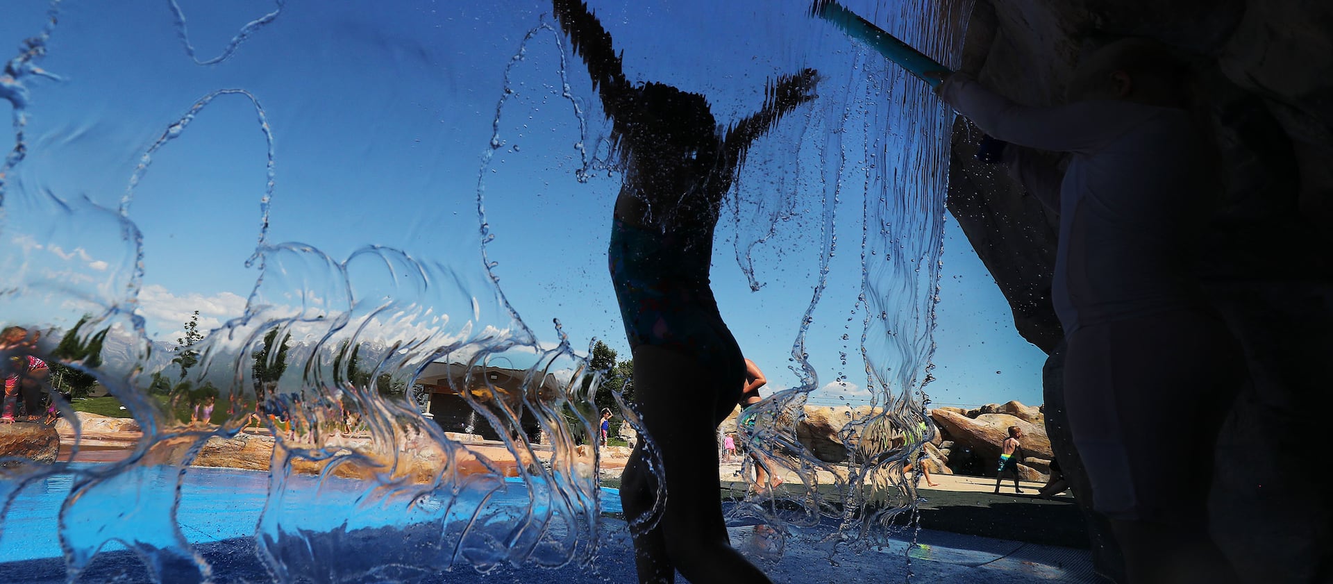 Children cool off in the water at Wardle Fields Regional Park splash pad in Bluffdale on June 3, 2021.