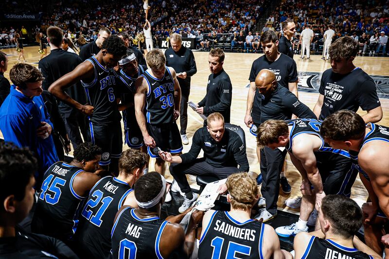BYU coach Kevin Young huddles up with his team during victory over Central Florida Friday in Orlando.