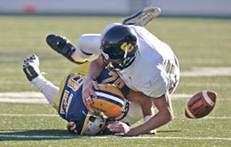 Snow College's Ty Sparrow, top, breaks up a reception attempt by Raymond Dorow of Rochester College in Top of the Mountains Bowl.