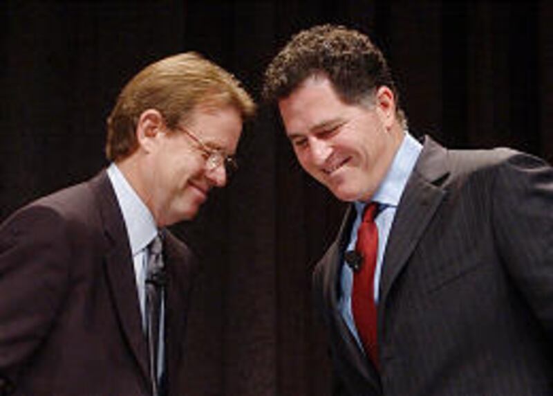 Kevin Rollins, left, has now officially received the title of CEO from Dell Inc. founder and chairman Michael Dell, right.