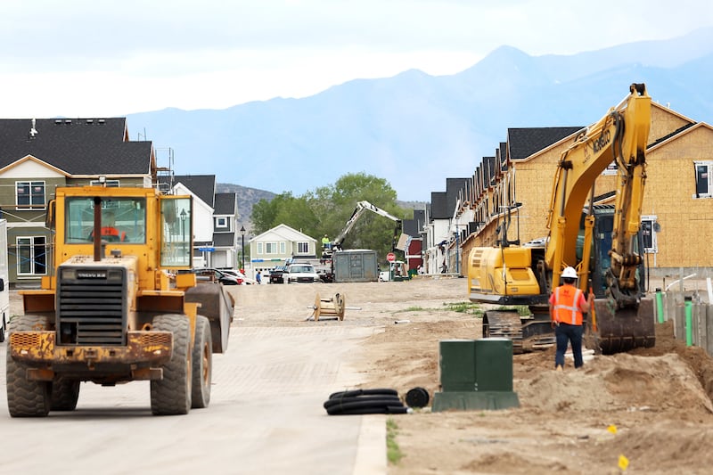Workers build a housing project in Saratoga Springs on Wednesday, May 23, 2018.