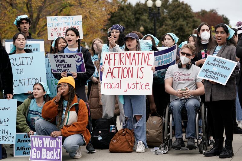 People rally outside the Supreme Court as the court begins in Washington.