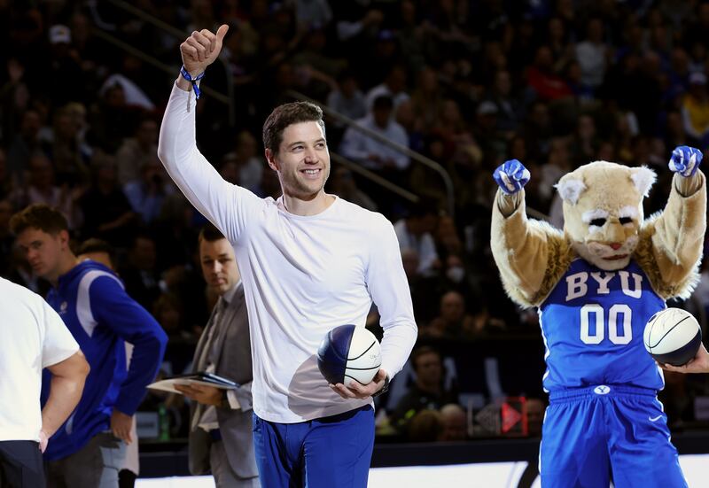 Former BYU star Jimmer Fredette gives a thumbs up to fans during a timeout as BYU and Utah play at the Marriott Center in Provo on Saturday, Dec. 17, 2022. BYU won 75-66.