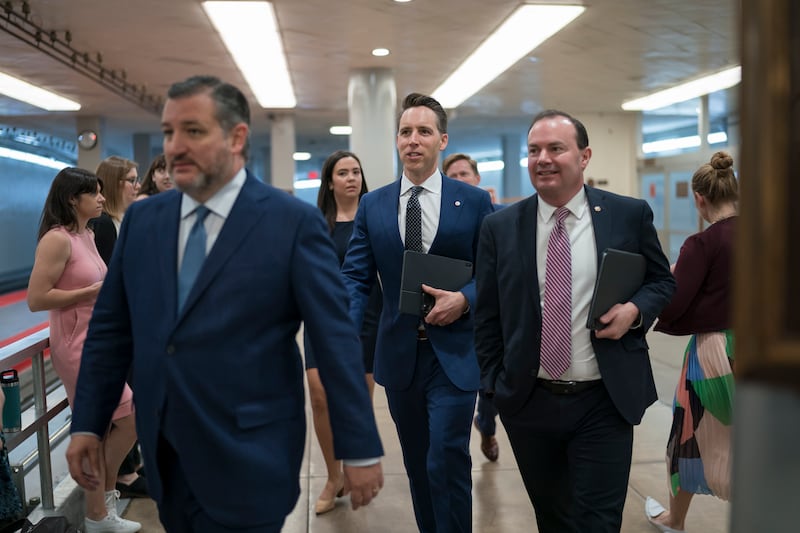 Sen. Ted Cruz, R-Texas, from left, Sen. Josh Hawley, R-Mo., and Sen. Mike Lee, R-Utah, arrive at the Senate chamber in Washington.