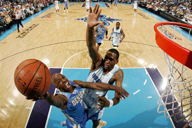 Nugget's Chauncey Billups goes up over the Hornets' Rasual Butler during Denver's 121-63 win on Monday.