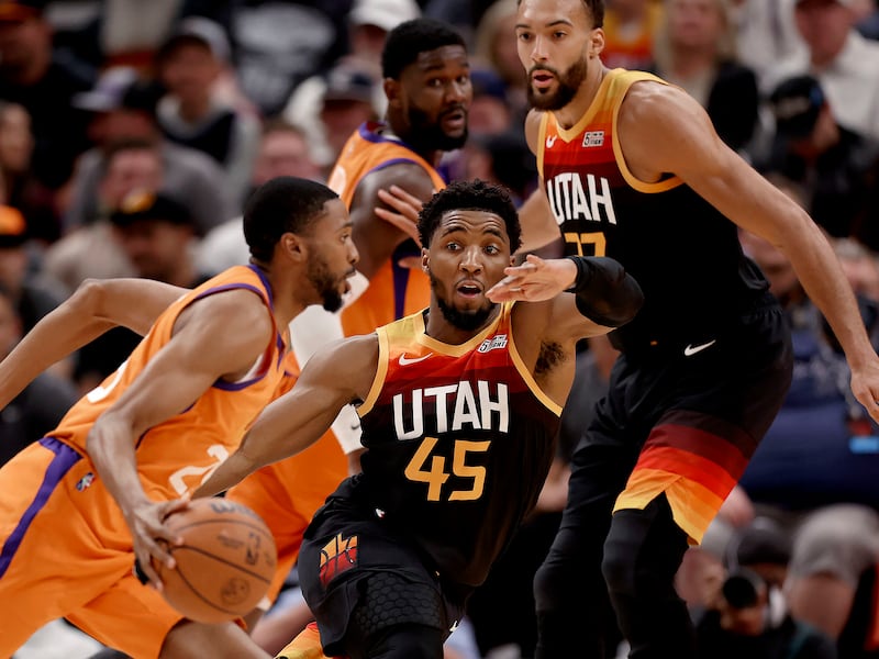 Phoenix Suns forward Mikal Bridges (25) drives the basket as Utah Jazz guard Donovan Mitchell (45) tries to stop him at Vivant Arena in Salt Lake City.
