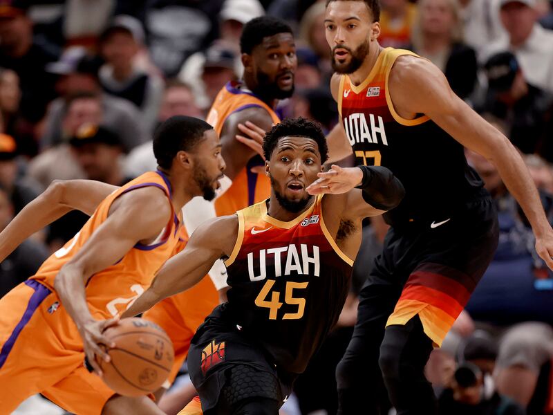 Phoenix Suns forward Mikal Bridges (25) drives the basket as Utah Jazz guard Donovan Mitchell (45) tries to stop him at Vivant Arena in Salt Lake City.