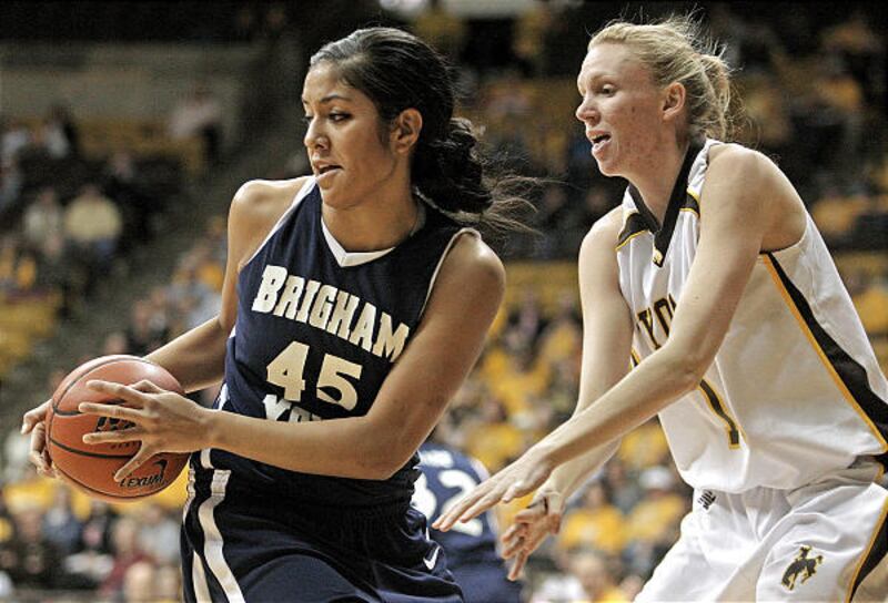 BYU's Keilani Moeaki, left, grabs a loose ball away from Wyoming forward Rebecca Vanderjagt during the Cougars' win Saturday.