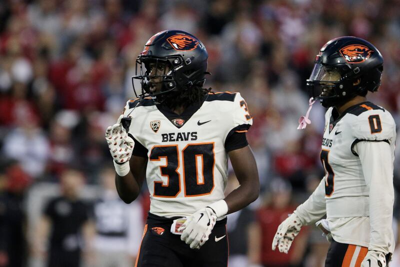 Oregon State’s Josiah Johnson (30) and back Akili Arnold stands on the field during game against Washington State.