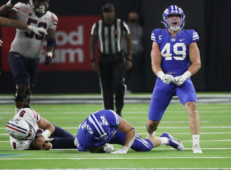 Brigham Young Cougars linebacker Payton Wilgar celebrates a play in 2021 in Las Vegas.
