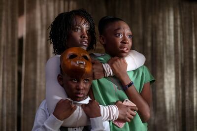 This image released by Universal Pictures shows, from left, Evan Alex, Lupita Nyong'o and Shahadi Wright Joseph in a scene from "Us," written, produced and directed by Jordan Peele.