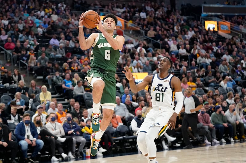 Milwaukee Bucks guard Elijah Bryant goes to the basket as Utah Jazz guard Miye Oni defends Oct. 13, 2021, in Salt Lake City.
