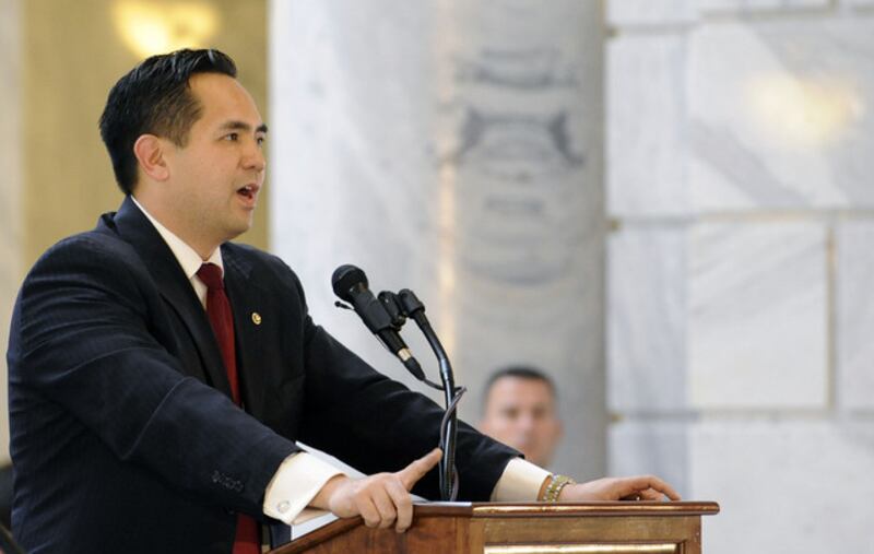 Utah Attorney General Sean Reyes speaks into microphones at a podium. Reyes has joined other GOP attorneys general in efforts to extend a COVID-era policy that allowed authorities to swiftly expel migrants at the border.