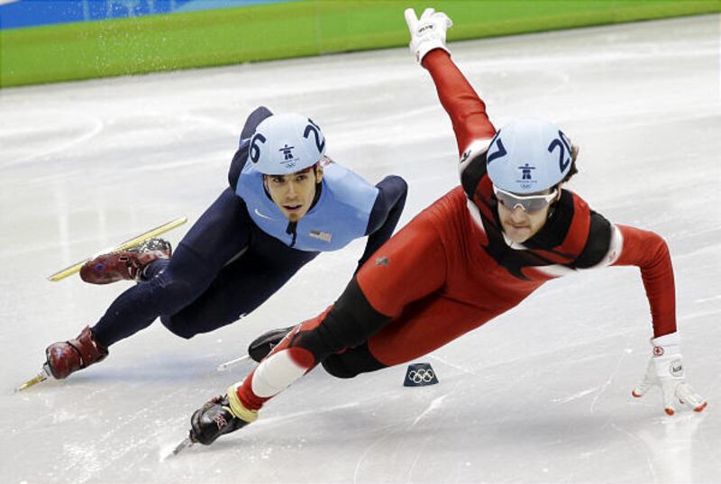 Apolo Anton Ohno, left, makes a move around Canada's Olivier Jean, during men's 500 short-track qualifying.