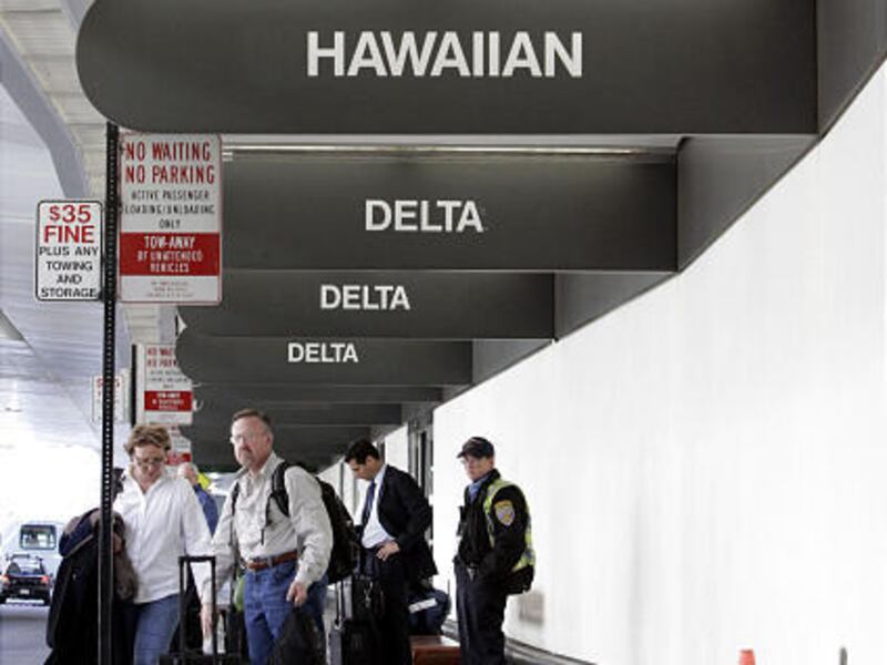 Delta Airlines, Northwest and Hawaiian signs are posted at San Francisco International Airport in San Francisco, Monday.