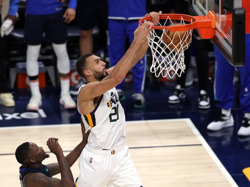 Utah Jazz center Rudy Gobert (27) slams down a dunk over Dallas Mavericks forward Dorian Finney-Smith (10) after taking an alley-oop pass from teammate Utah Jazz guard Donovan Mitchell (45) as the Utah Jazz and the Dallas Mavericks play Game 4 at Vivint Arena in Salt Lake City on Saturday, April 23, 2022. Utah won 100-99.