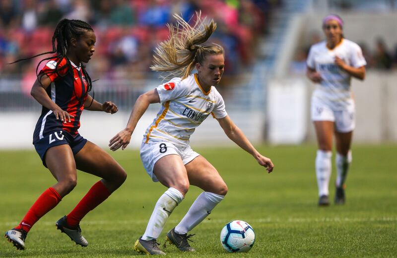 In this April 20, 2019, file photo, Utah Royals FC forward Amy Rodriguez (8) dribbles the ball against Washington Spirit forward Cheyna Williams (20) at Rio Tinto Stadium in Sandy.