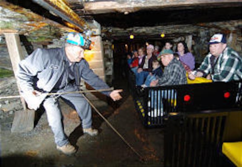 Beckley Exhibition Coal Mine tour guide and retired coal miner George Archibald demonstrates a tamping rod during an underground tour.