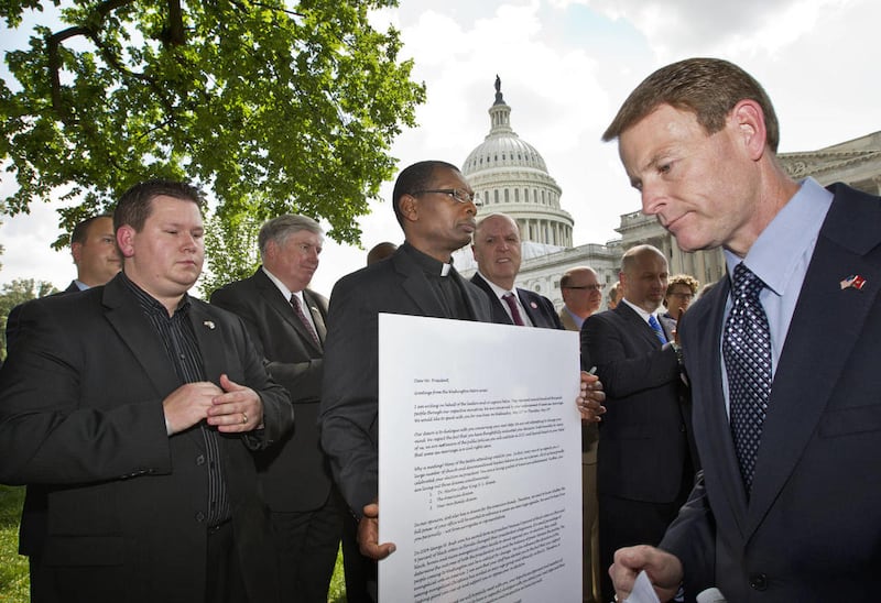 Family Research Council President Tony Perkins, right, finishes his speech denouncing gay marriage as a group of pastors from across denominational lines gather on Capitol Hill in Washington, Thursday, May 24, 2012, during a news conference to show their