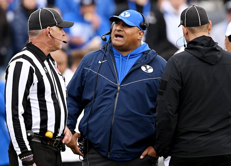 BYU coach Kalani Sitake talks with an official as BYU and Oklahoma play at LaVell Edwards Stadium in Provo on Nov. 18, 2023.