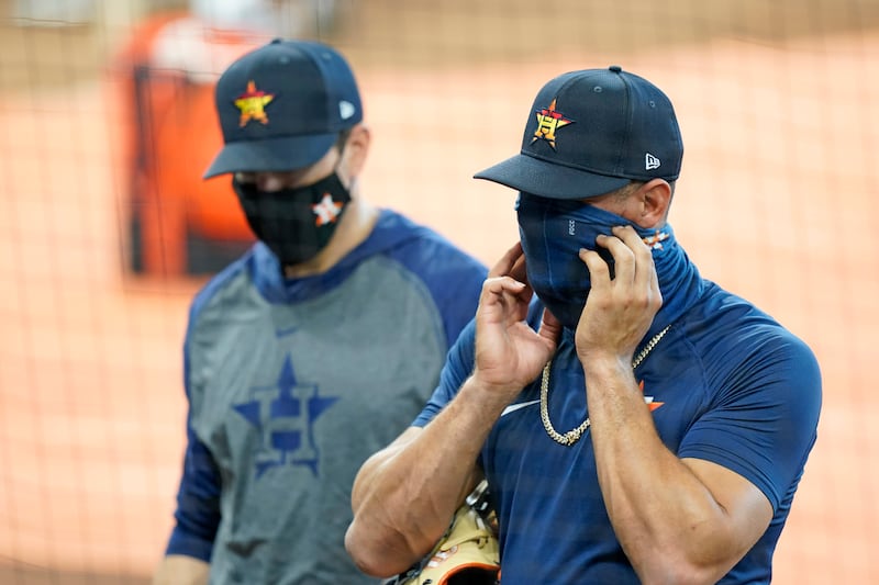 Houston Astros first baseman Yuli Gurriel adjusts his mask during batting practice before a baseball game against the San Francisco Giants Monday, Aug. 10, 2020, in Houston. (AP Photo/David J. Phillip)