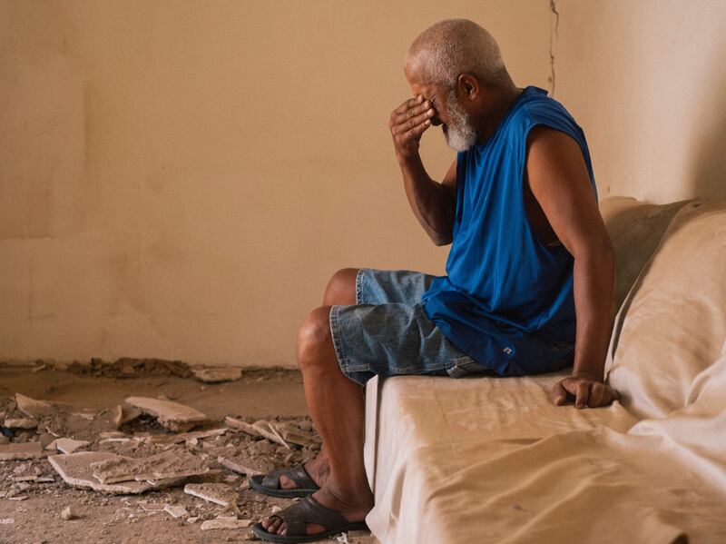 A man reacts as he speaks about the damage caused by the earthquake to his home, in the old Medina of Marrakech, Morocco.