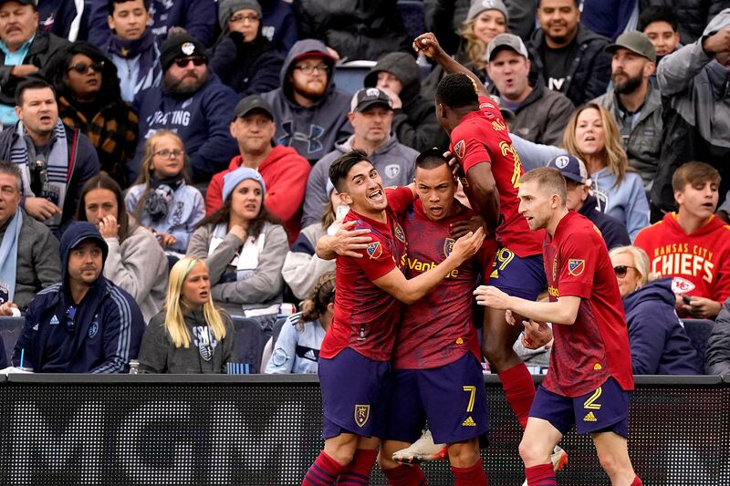 Real Salt Lake forward Bobby Wood (7) celebrates with teammates after scoring the winning goal during the second half of an MLS soccer match against Sporting Kansas City.