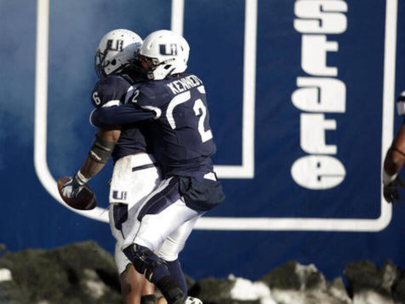 Utah State Aggies running back Robert Turbin (6) and Utah State Aggies quarterback Adam Kennedy (2) celebrates a touchdown in Logan Saturday, Nov. 26, 2011.