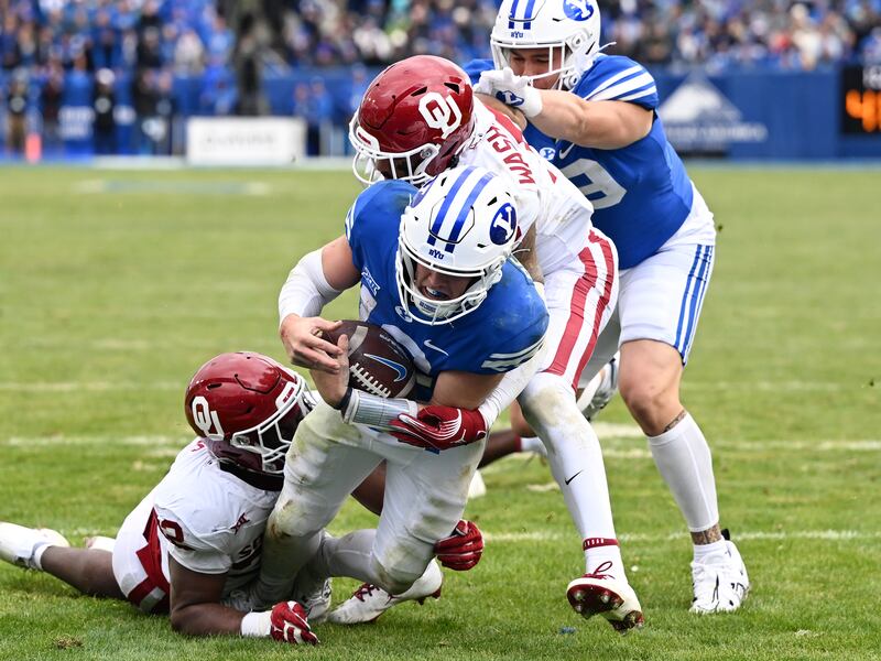 Brigham Young Cougars quarterback Jake Retzlaff (12) scores a touchdown on Saturday, Nov. 18, 2023.