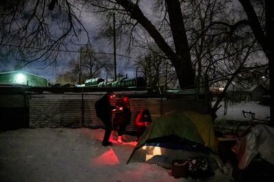Shawn Spalding, Elizabeth Baron and Brooke Pyper, all with Volunteers of America - Utah, talk through the tent walls with two men who are homeless during the annual Point-in-Time count in South Salt Lake on Thursday, Jan. 24, 2019.