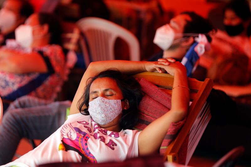 Relatives of patients sleep under a red tarp set up outside the COVID-19 section of the Clinicas Hospital.